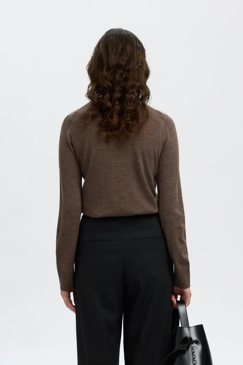 Brown merino wool long-sleeve O-neck knit sweater, back view, paired with black trousers