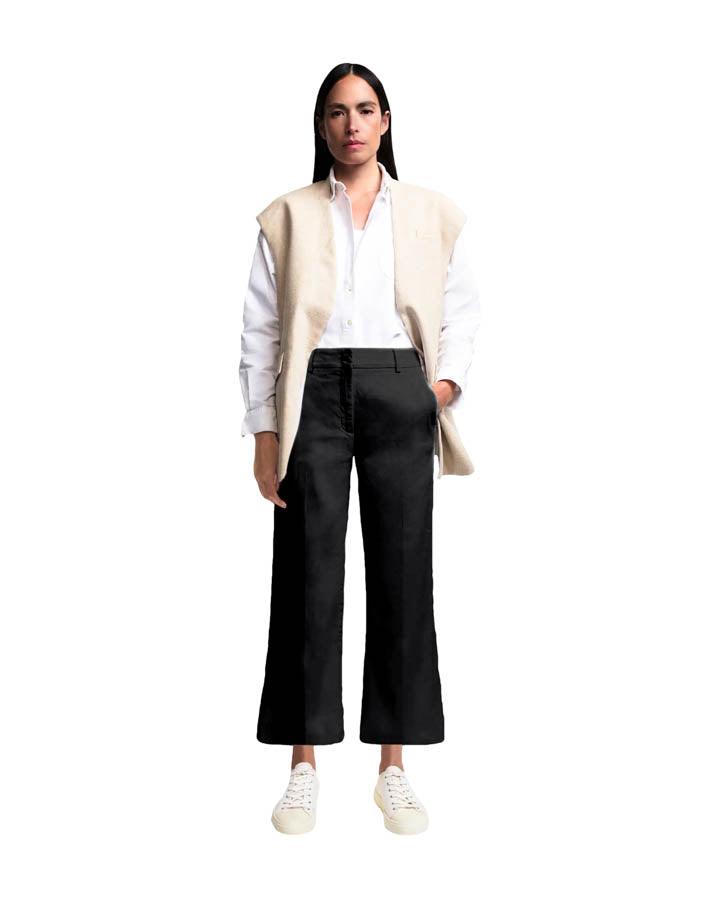 Model wearing Cambio California wide-leg cropped black trousers with white shirt and vest.