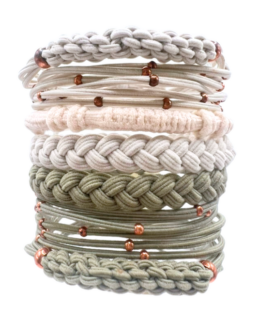Stack of braided and knotted hair ties in neutral tones with rose gold beads