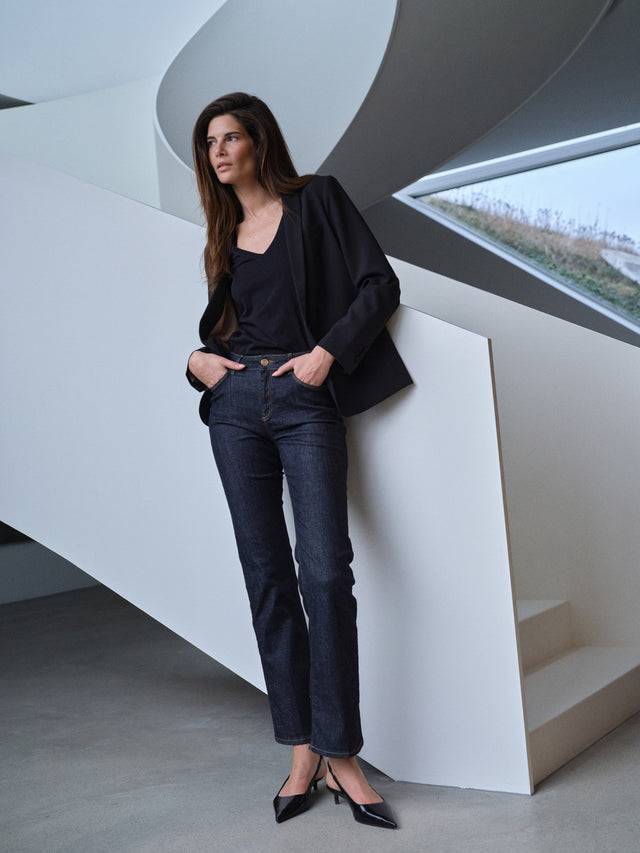 Black oversized blazer worn with dark jeans and black top, relaxed fit
