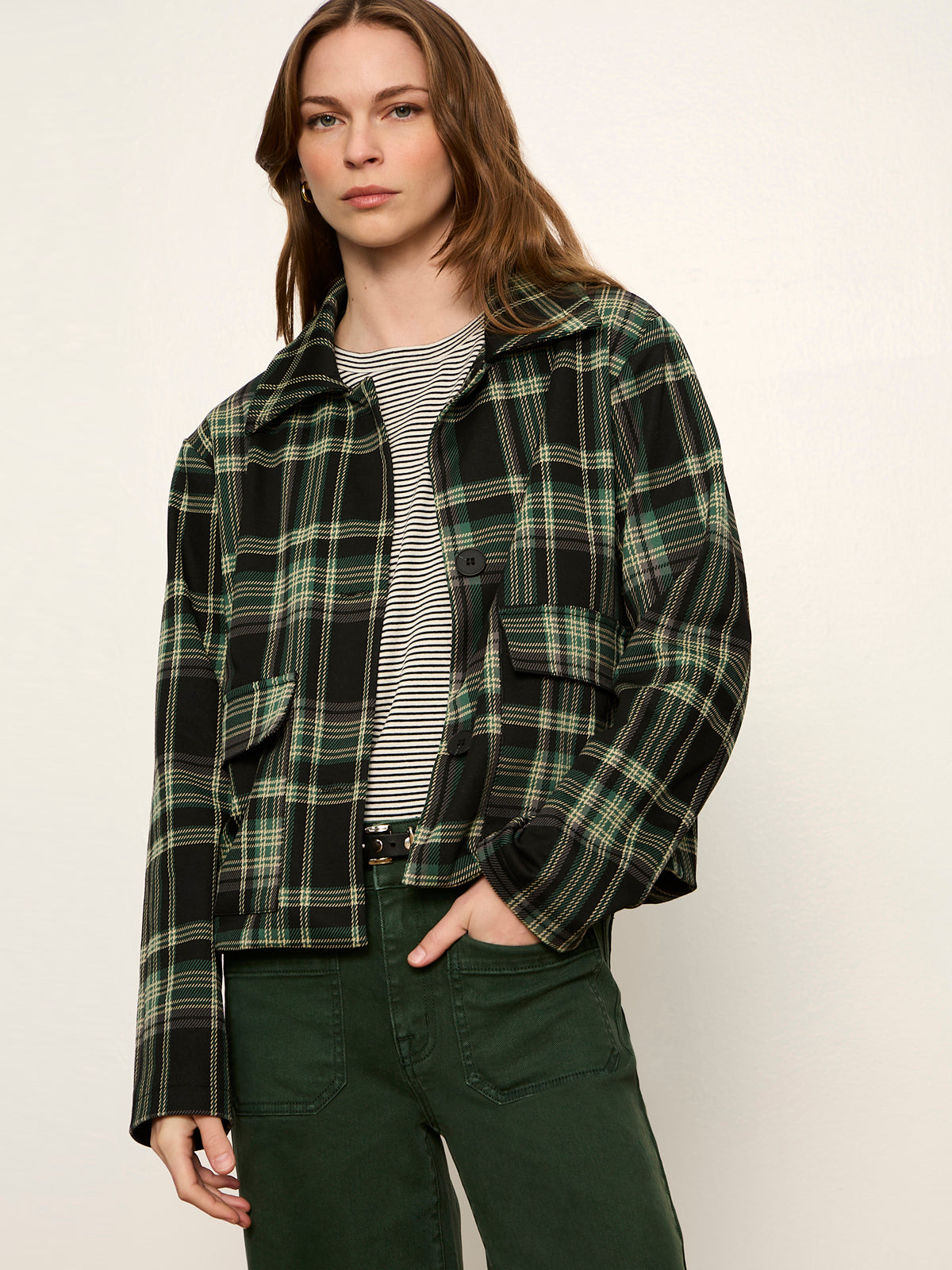 Model wearing Sanctuary Avid Plaid Jacket in dark green and black plaid pattern