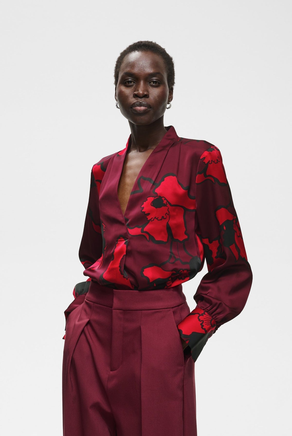 Burgundy floral satin V-neck blouse with red poppy print and elasticated cuffs