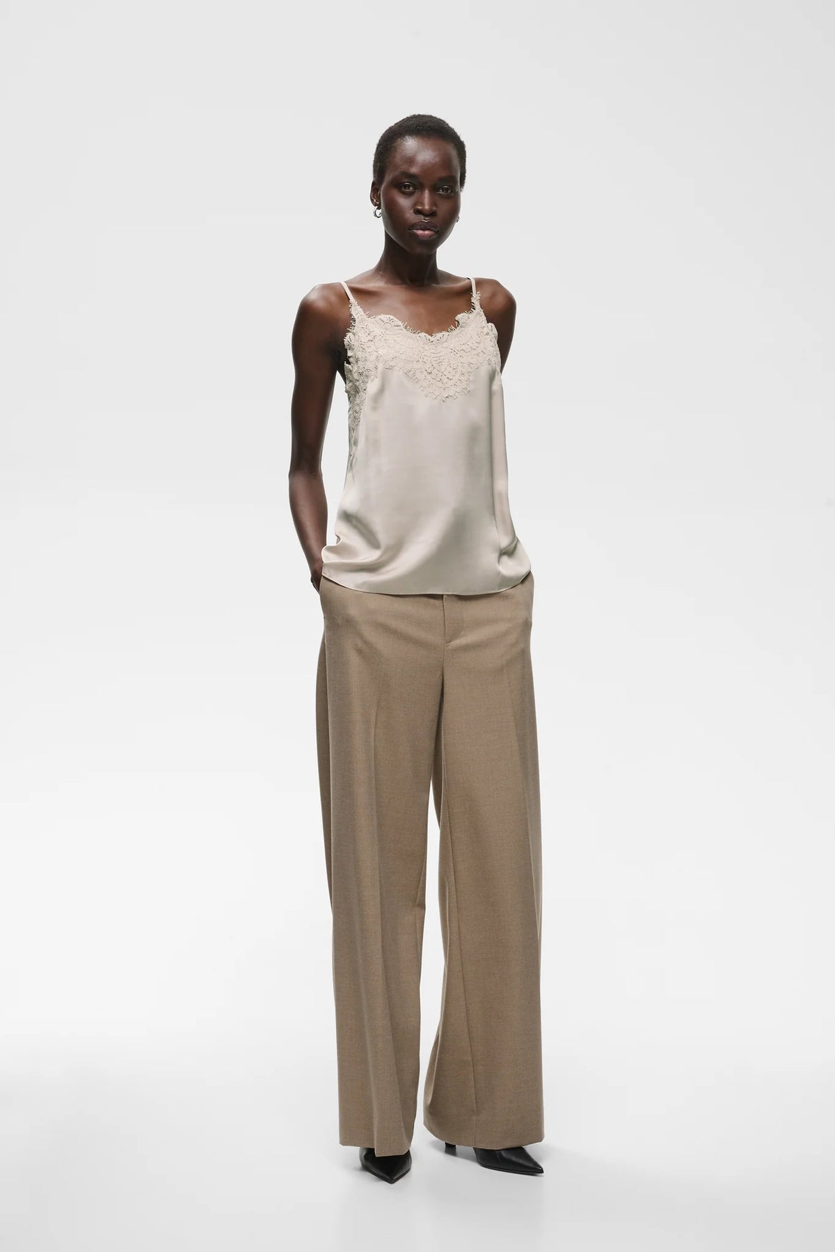 Beige satin camisole with lace trim neckline and thin straps