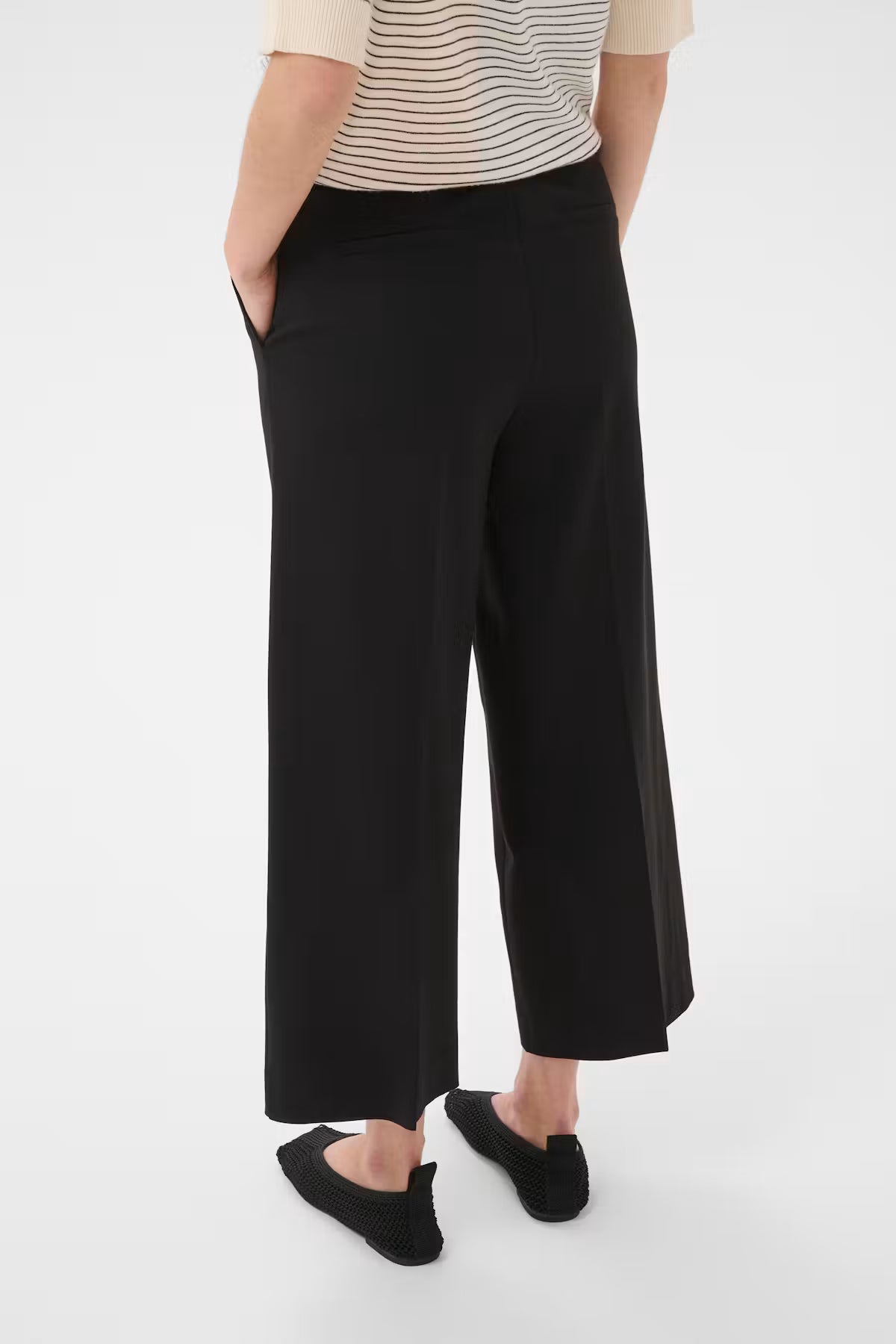 Part Two Conchita black wide-leg cropped trousers, back view, worn with flat shoes