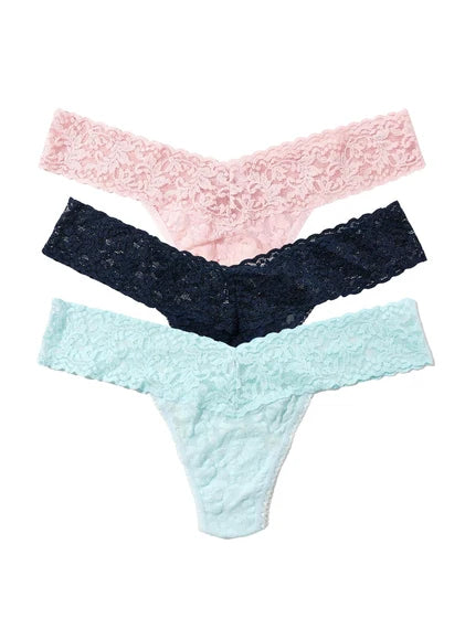 Three lace thongs in blush pink, navy blue, and mint green stacked flat