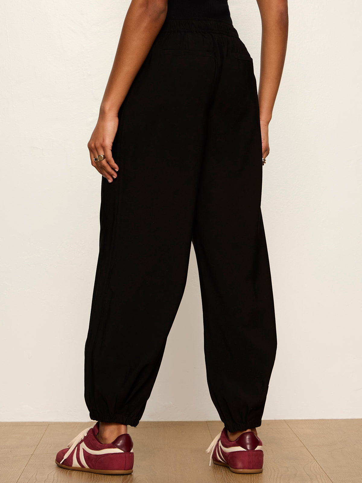 Back view of Sanctuary Micro Balloon Pant in black with elastic waistband and cuffed ankles