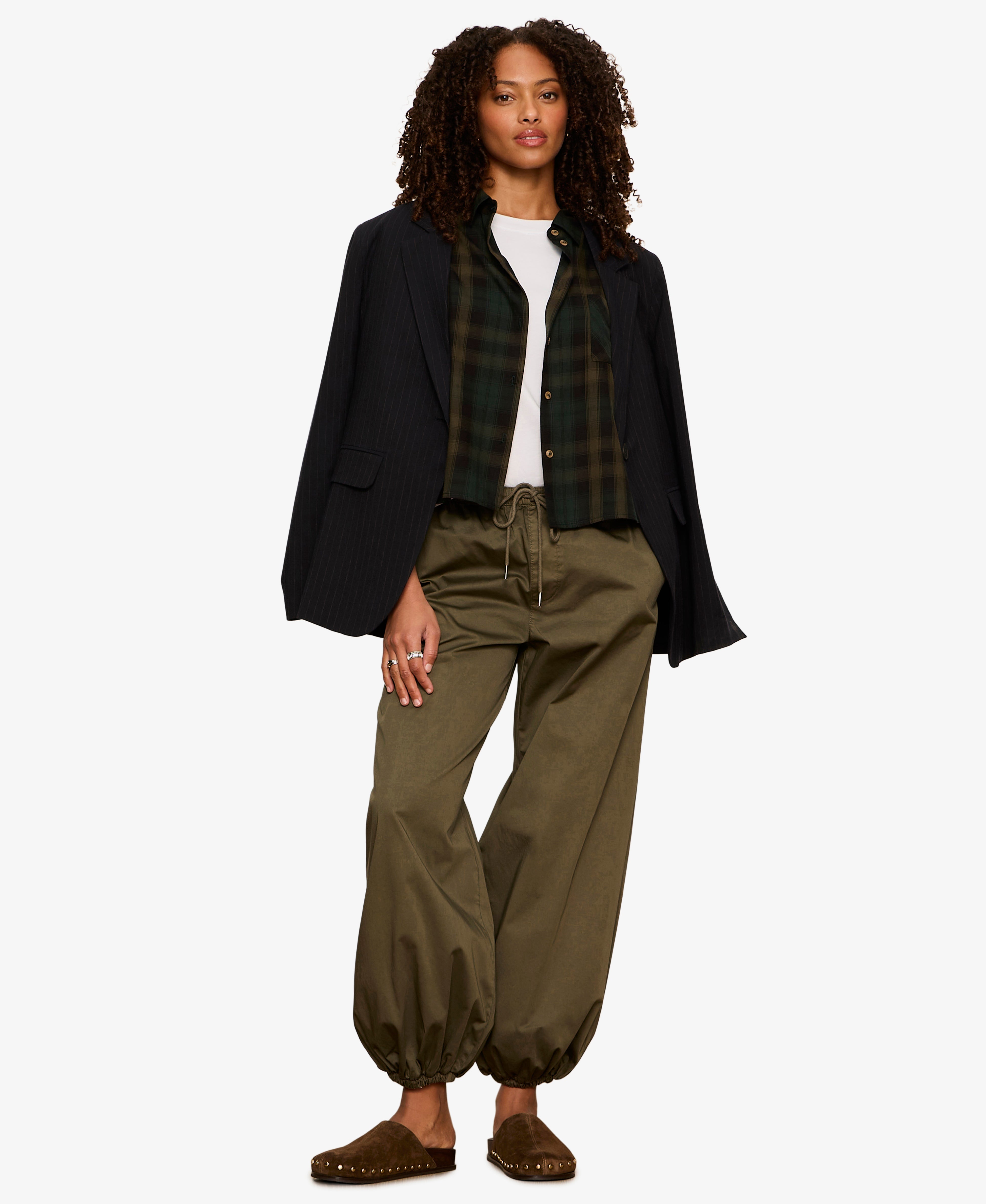 Model wearing Sanctuary Float On Balloon pants in olive kalamata with black blazer and plaid shirt