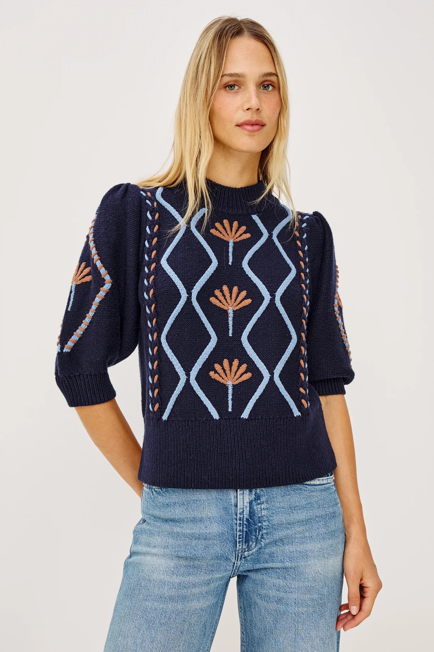 Model wearing Rails Addy navy knit sweater with floral cable pattern and puff sleeves