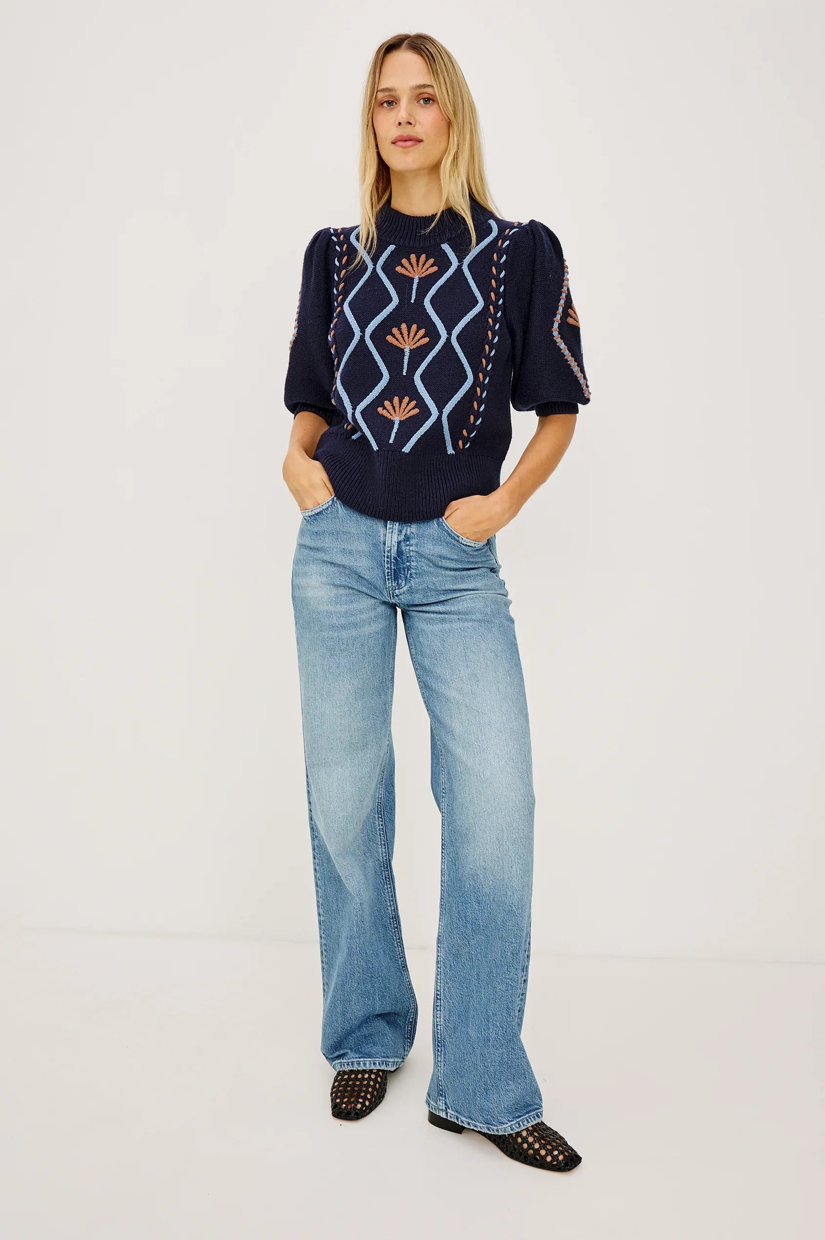 Model wearing Rails Addy navy knit sweater with floral cable embroidery and puff sleeves