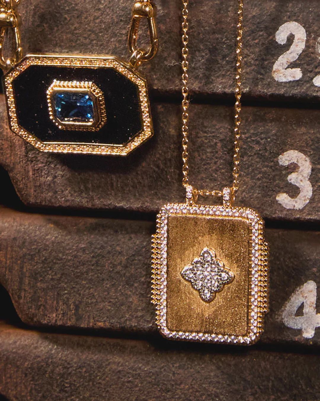 Gold rectangular pendant necklace with diamond border and floral motif centerpiece