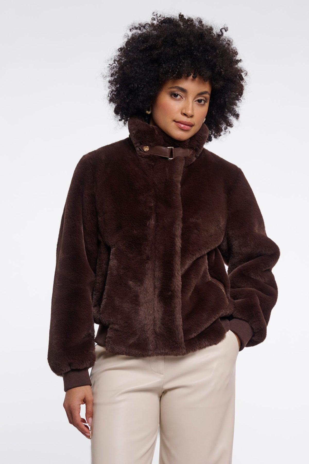Woman wearing RINO & PELLE AMBRA faux fur jacket in deep chocolate brown with ribbed cuffs