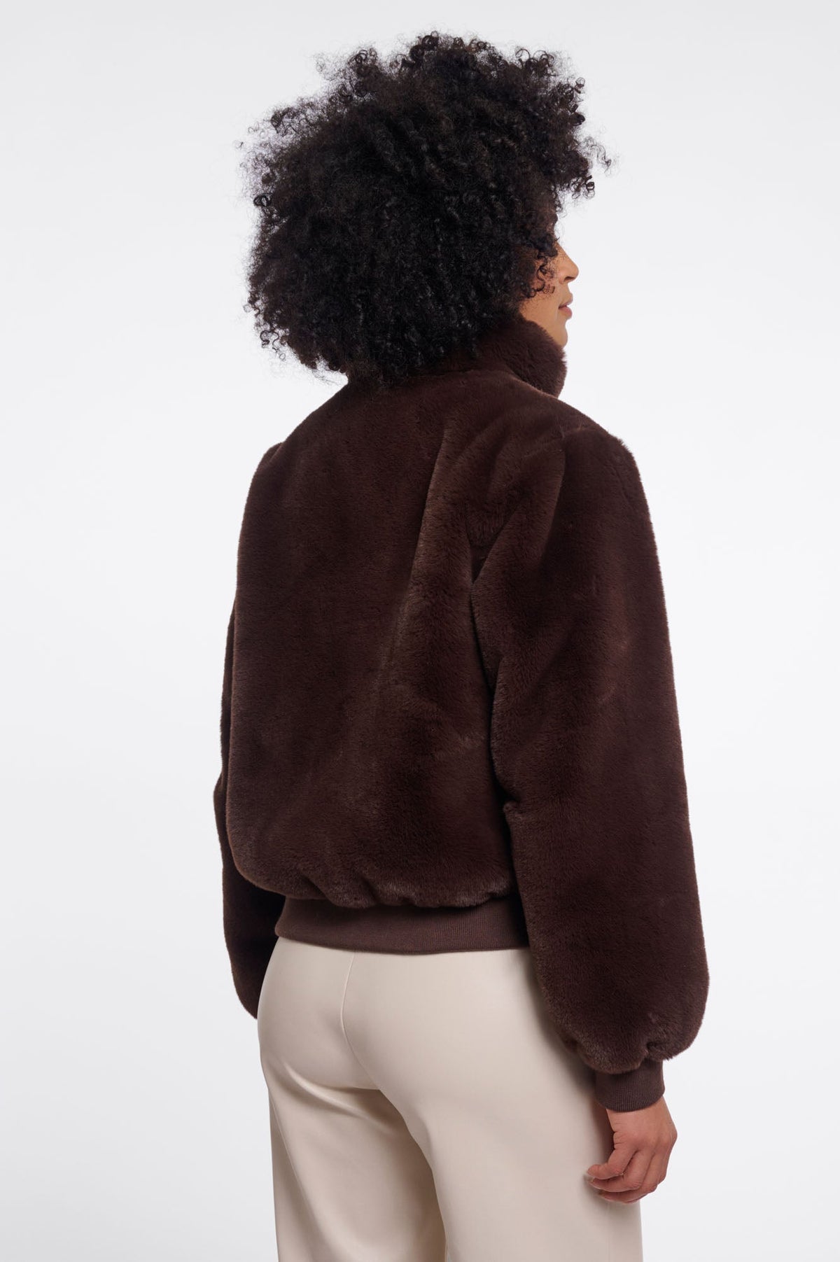 Back view of RINO & PELLE AMBRA faux fur bomber jacket in Coffee Roast brown on model