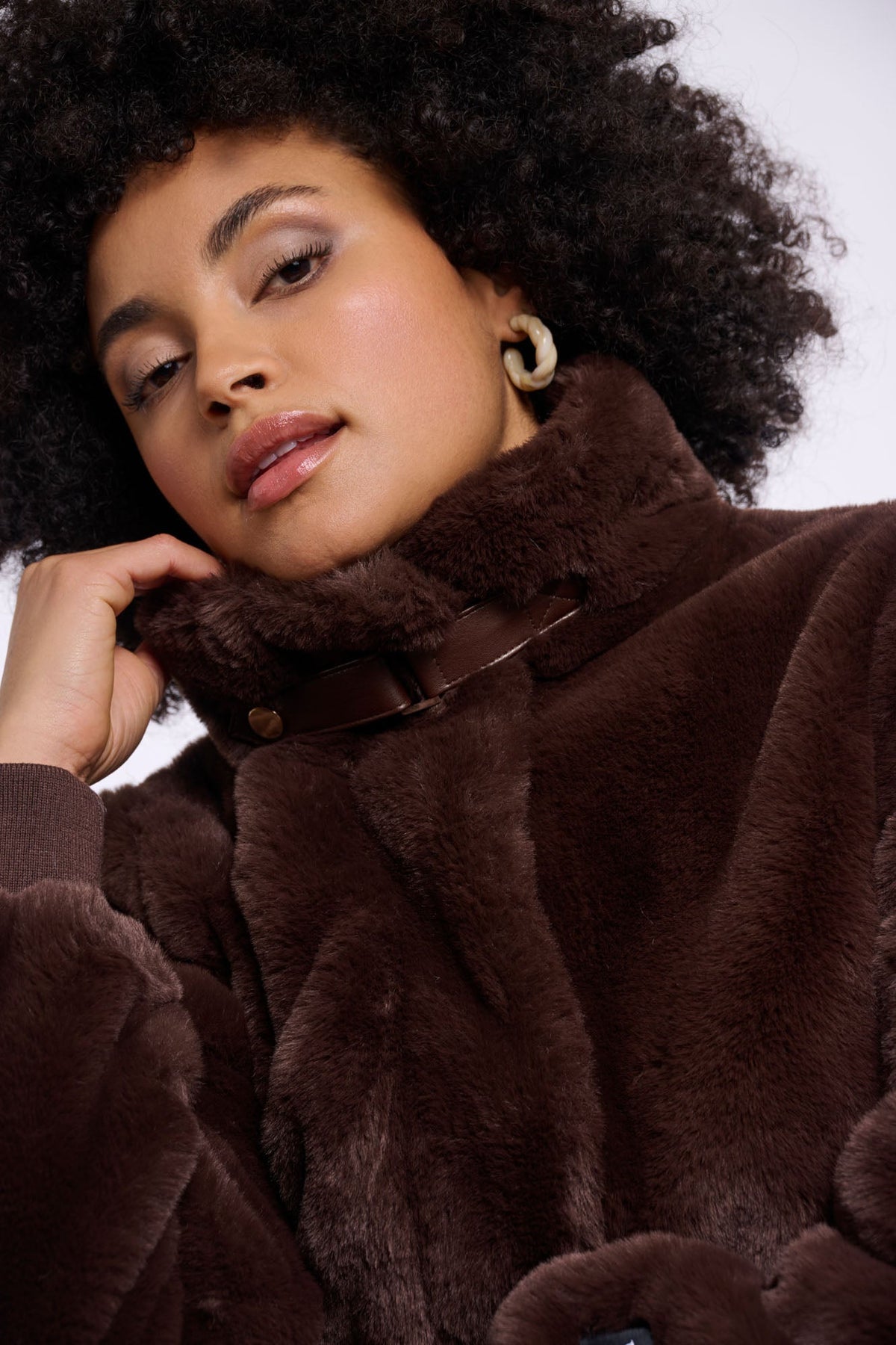 Model wearing Rino & Pelle Ambra faux fur coat in Coffee Roast brown with leather collar detail