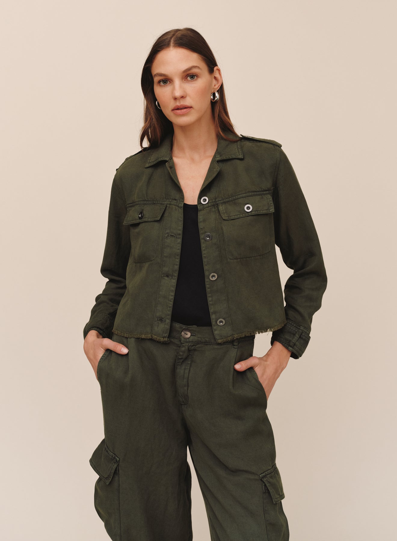 Model wearing Bella Dahl cropped utility jacket with fray hem in smoked olive with matching cargo pants