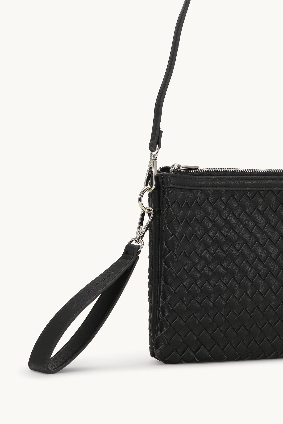 Black woven leather clutch bag with silver zipper, crossbody strap and wrist handle detail
