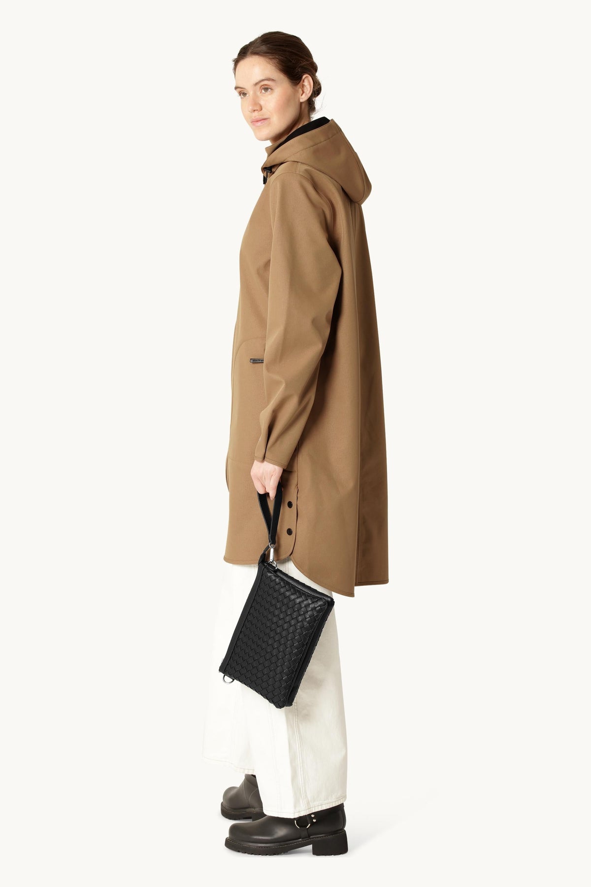 Model holding black quilted leather clutch bag BAG08CB by Ilse Jacobsen, side view