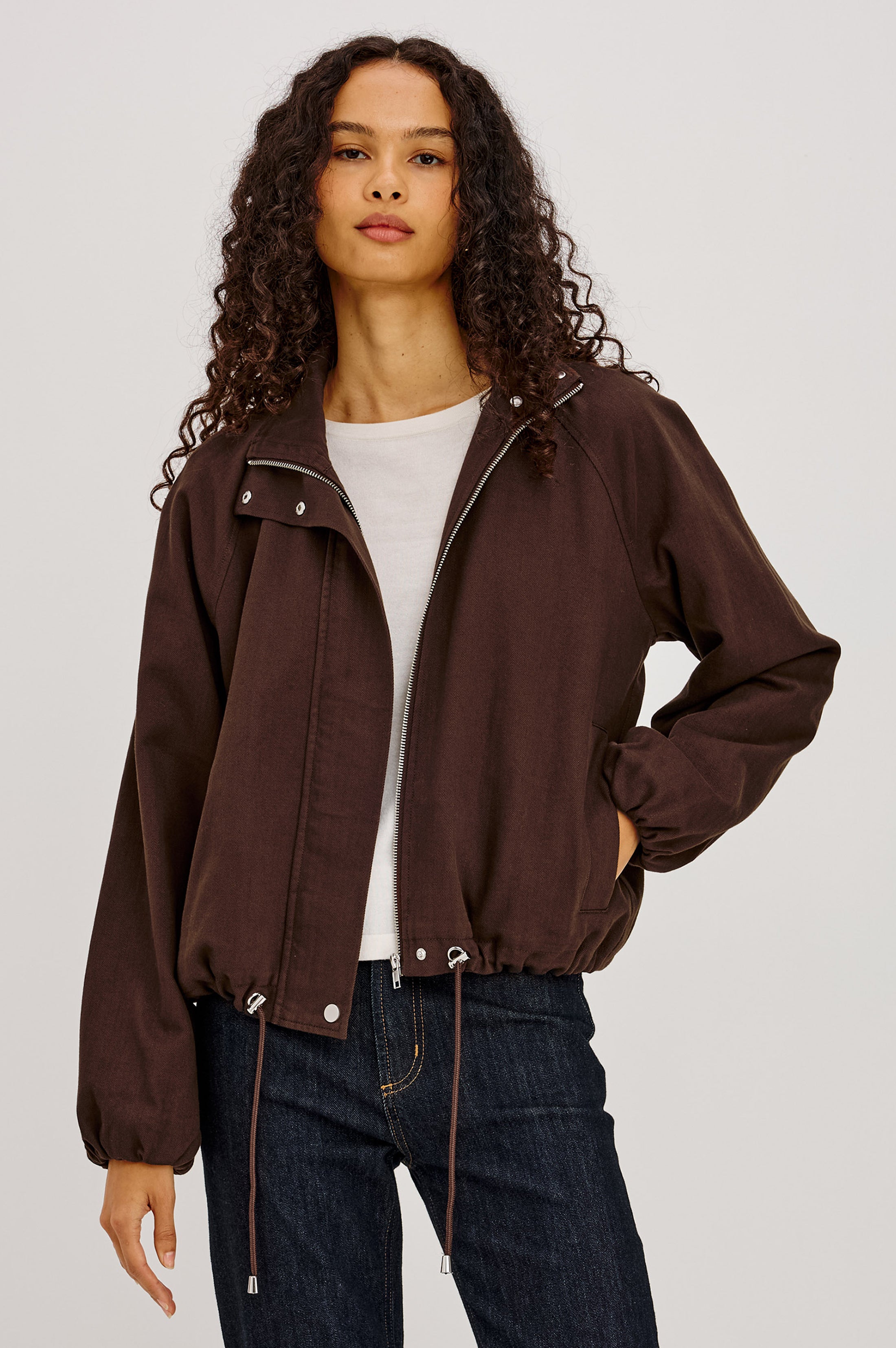 Woman wearing Rails Blake jacket in espresso dark brown with zipper and drawstring hem