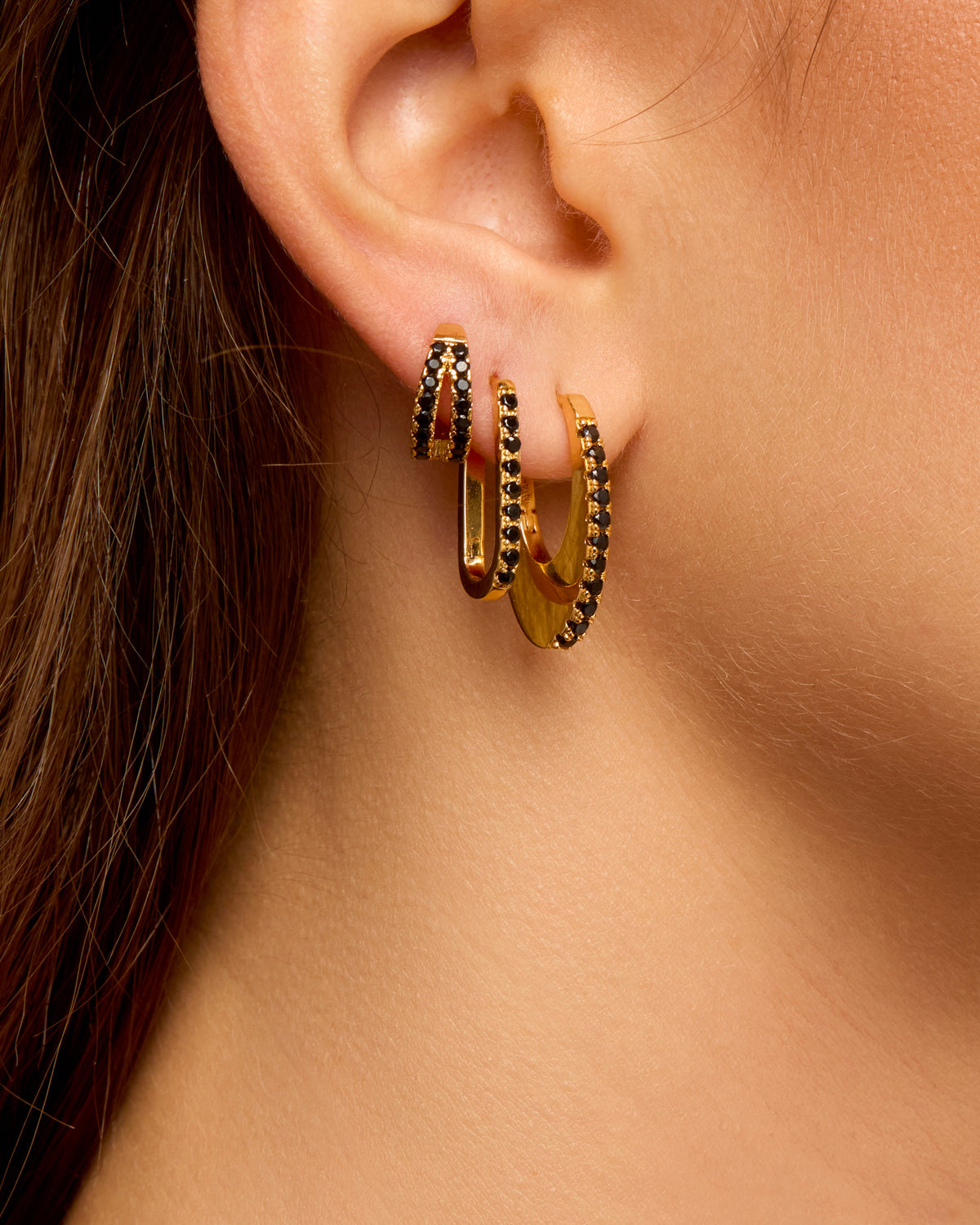 MYA-BAY Black Stellar gold hoop earrings with black crystal pavé worn on ear