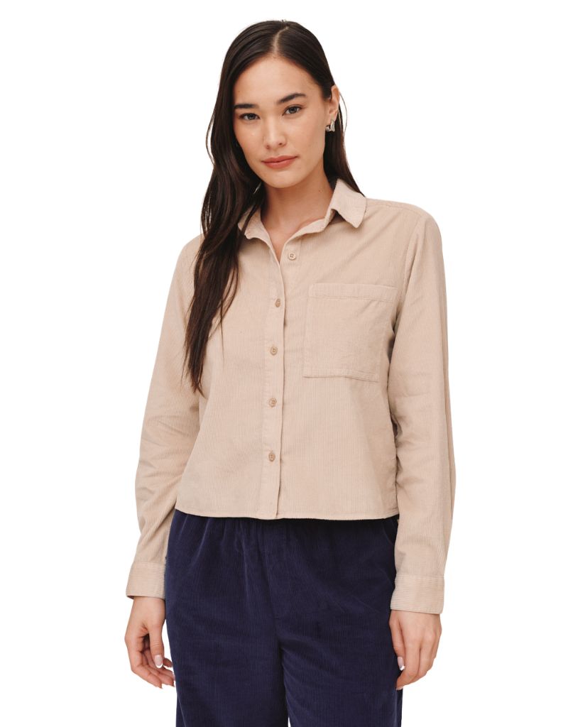 Woman wearing Bella Dahl long sleeve corduroy patch pocket shirt in oat beige color