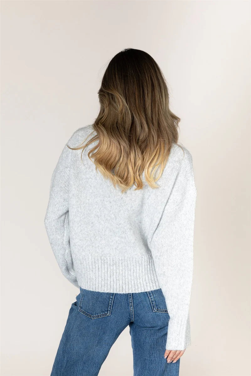 Lyla & Luxe Calli light grey knit sweater back view with ribbed hem