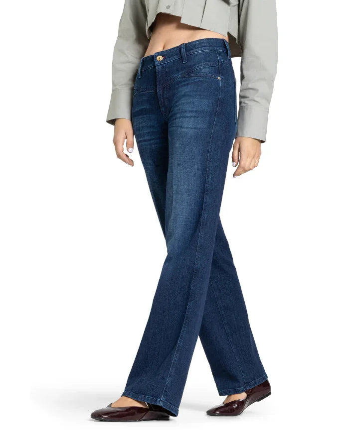 Cambio Aimee bootcut jeans in dark indigo stoned wash worn by female model with flats