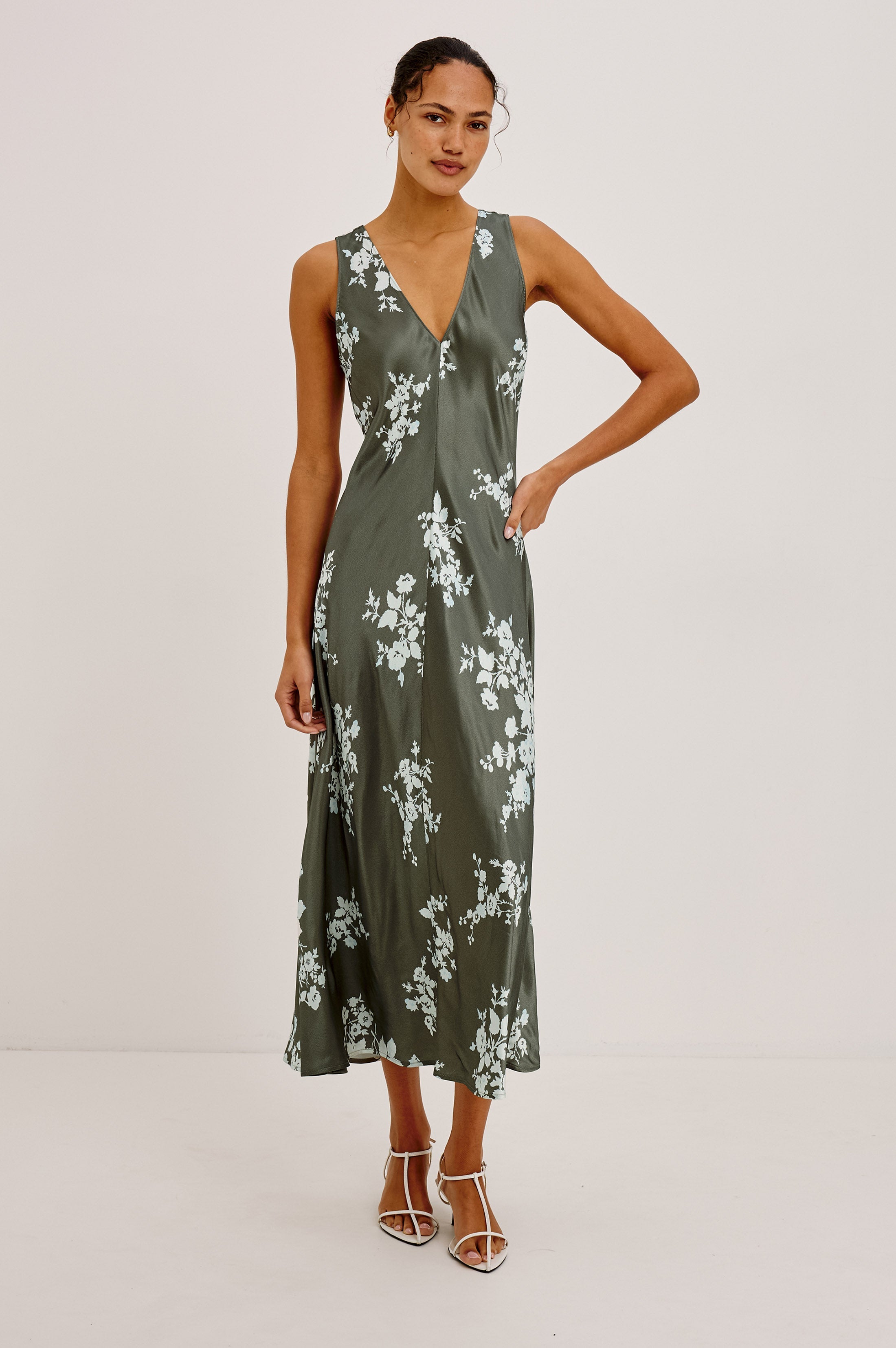 Model wearing Rails Camellia midi slip dress in olive green lace floral print with V-neck