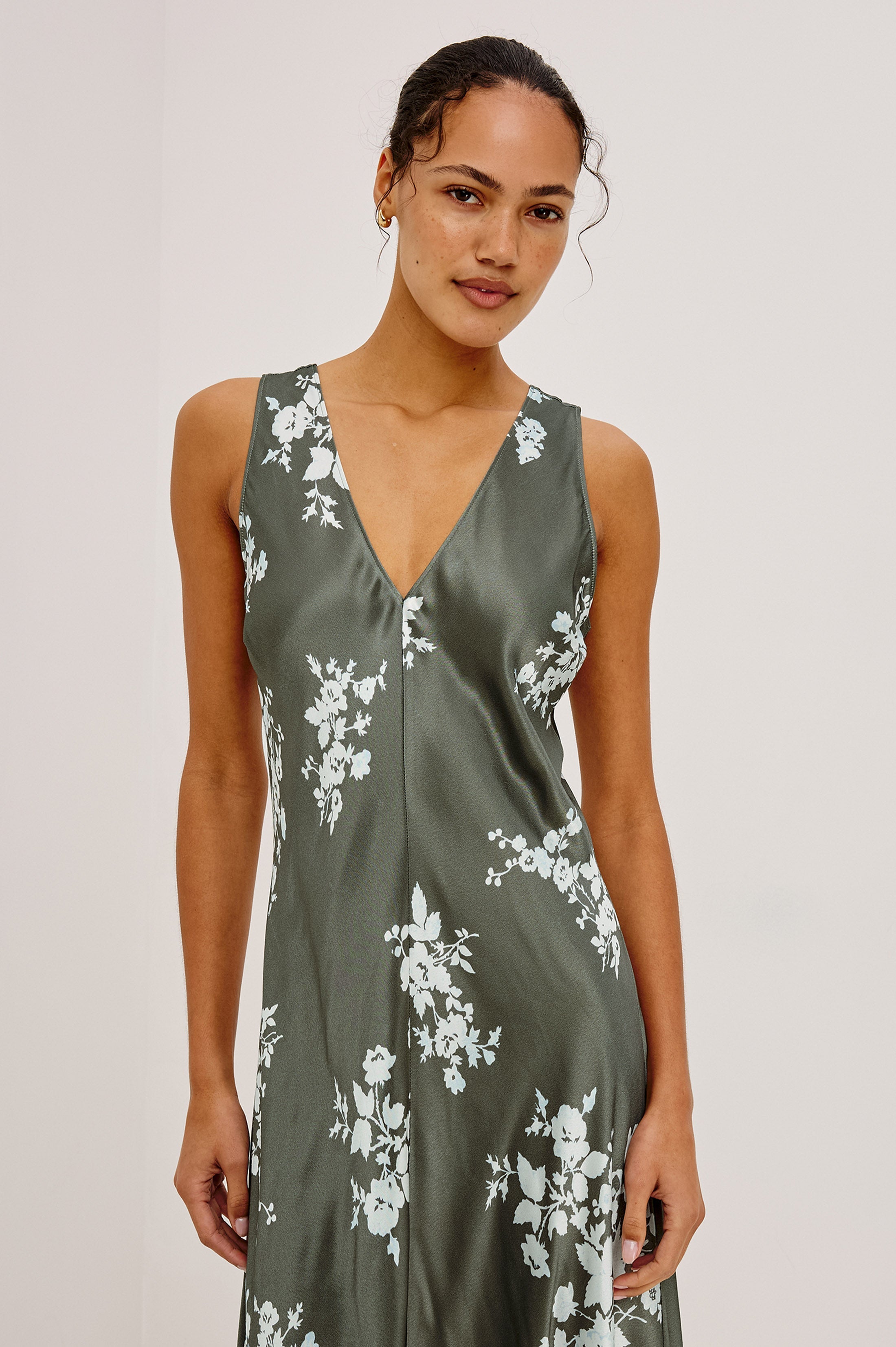 Model wearing Rails Camellia slip dress in olive green with white floral lace print, V-neckline