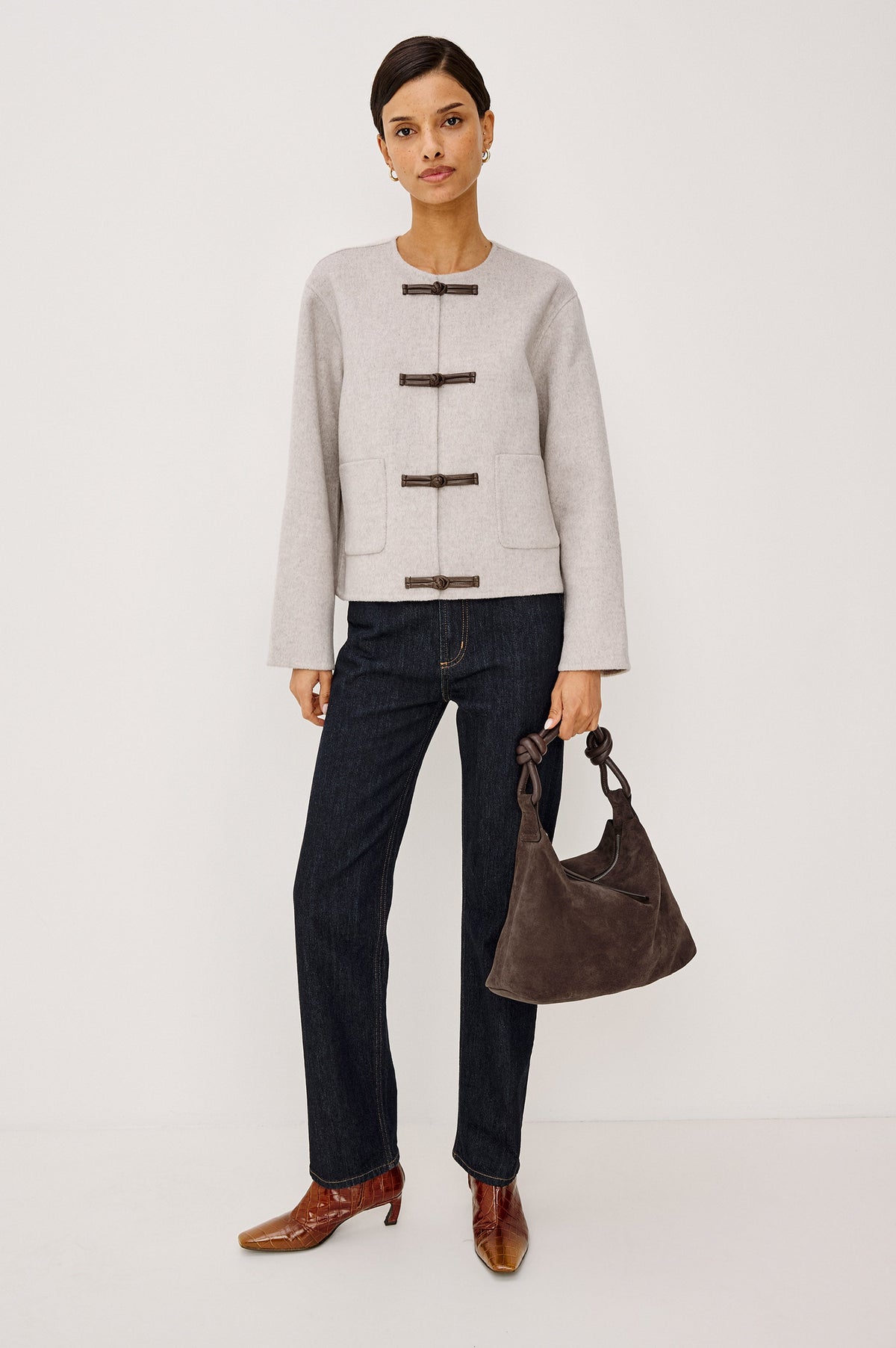Model wearing Rails Deidre jacket in heather oat with toggle closures, paired with dark jeans