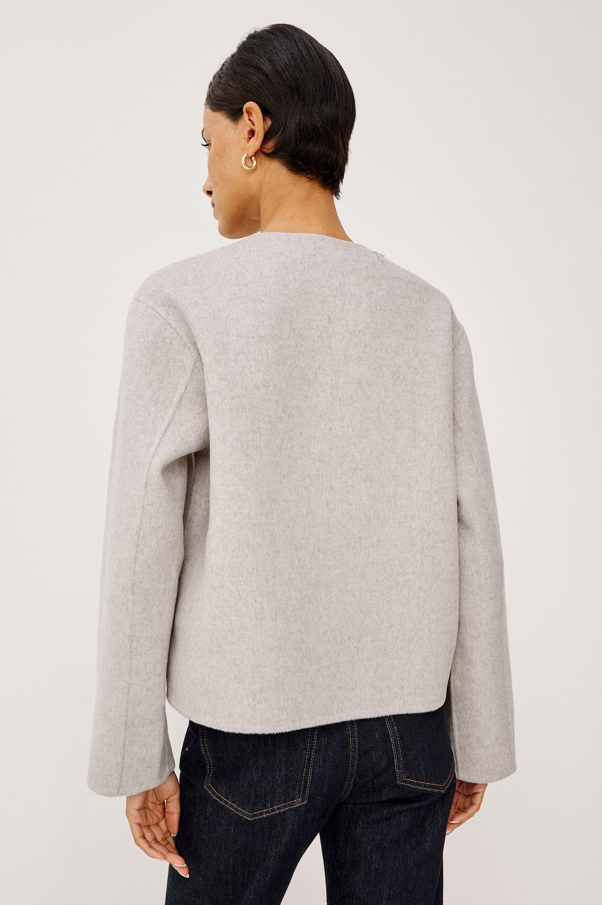 Back view of Rails Deidre sweater in heather oat on a model wearing dark jeans