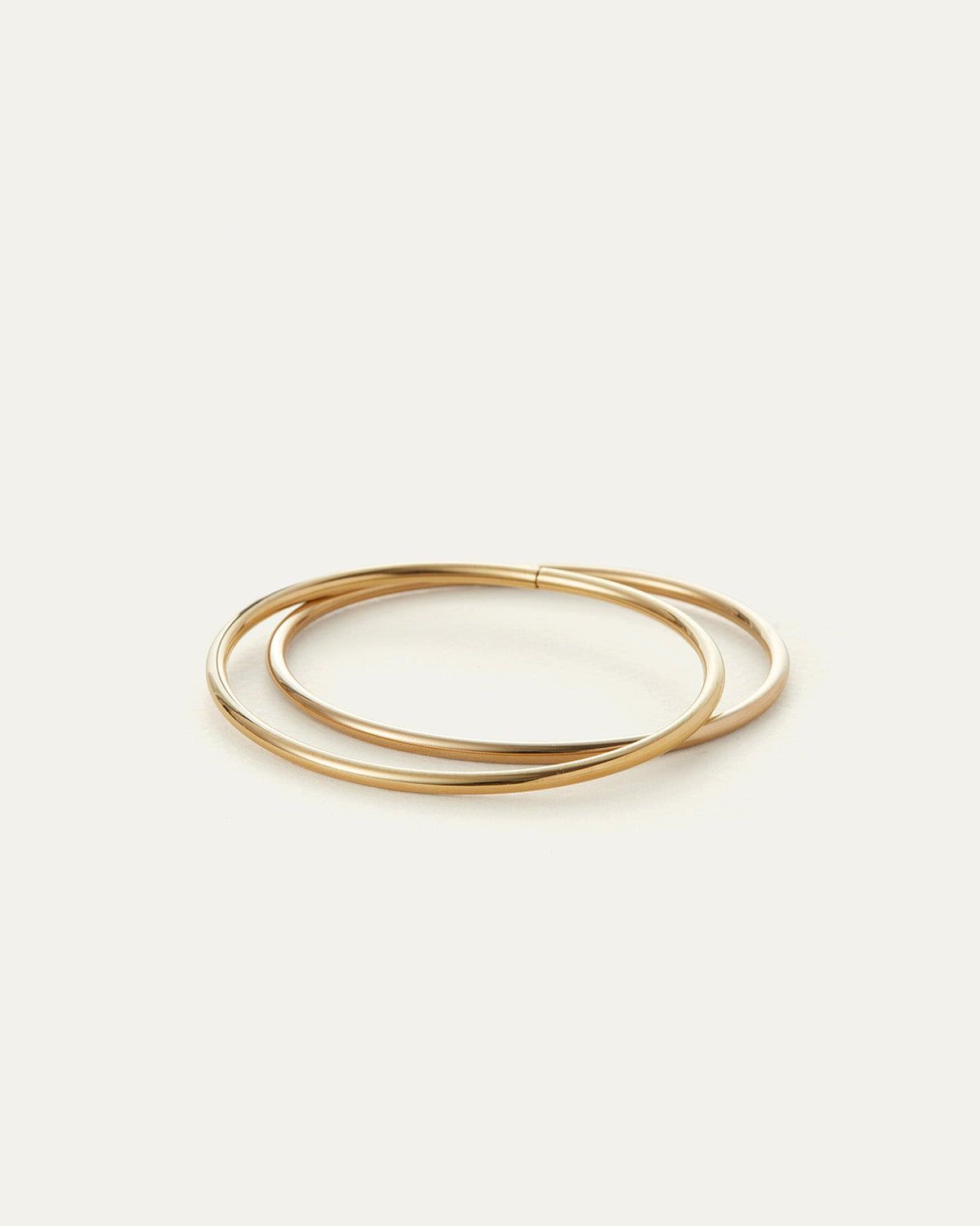 Jenny Bird Dane Bangle Set of two slim polished gold-tone bangles on white background