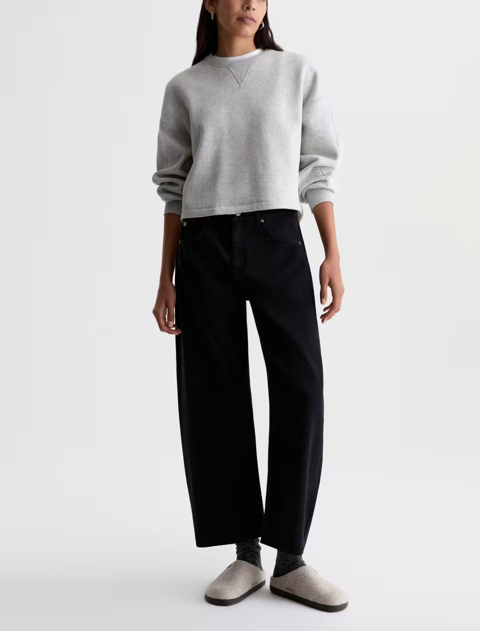AG Hattie wide-leg black jeans paired with gray cropped sweatshirt and slip-on shoes