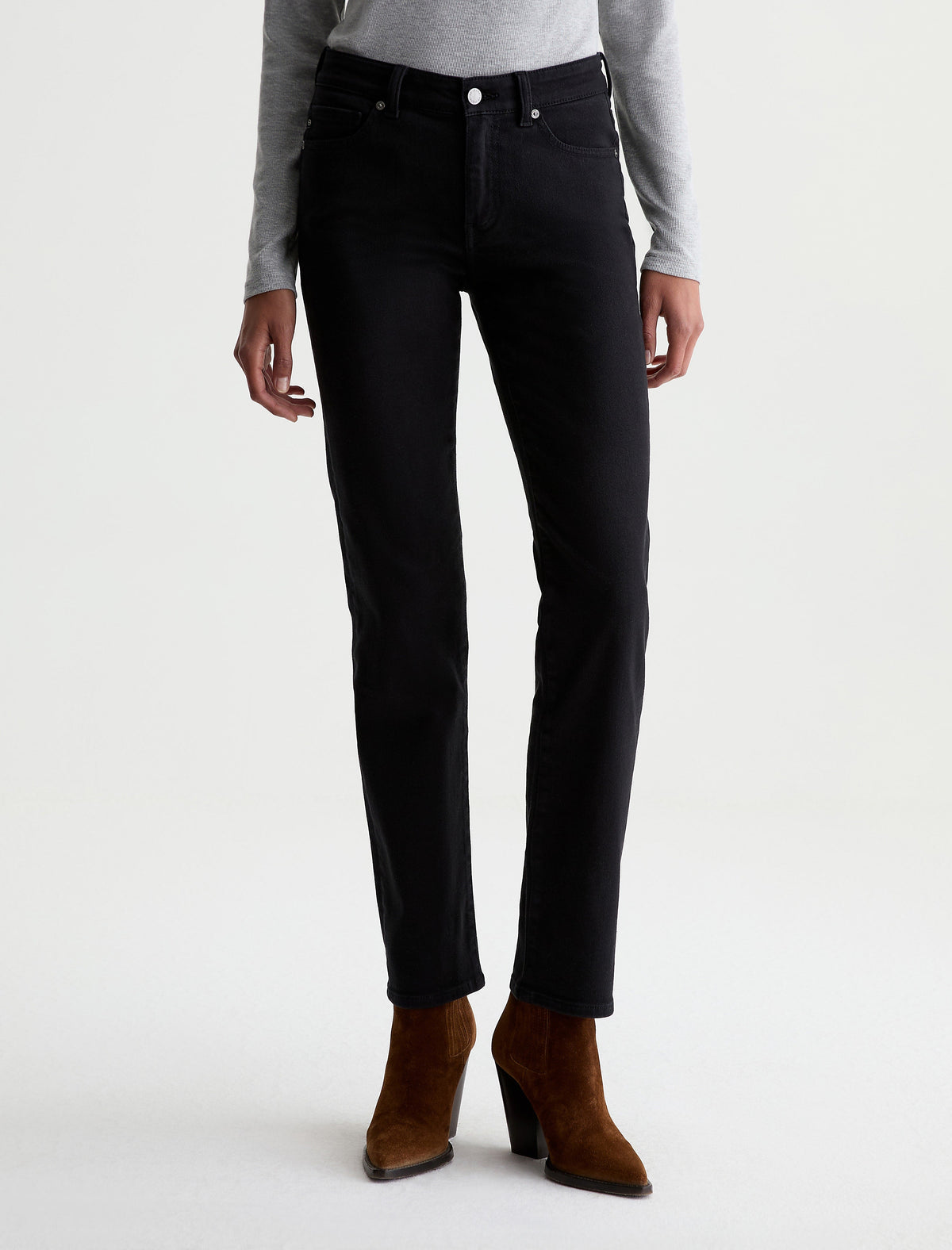 AG Sandra slim straight black jeans worn by model with brown suede boots