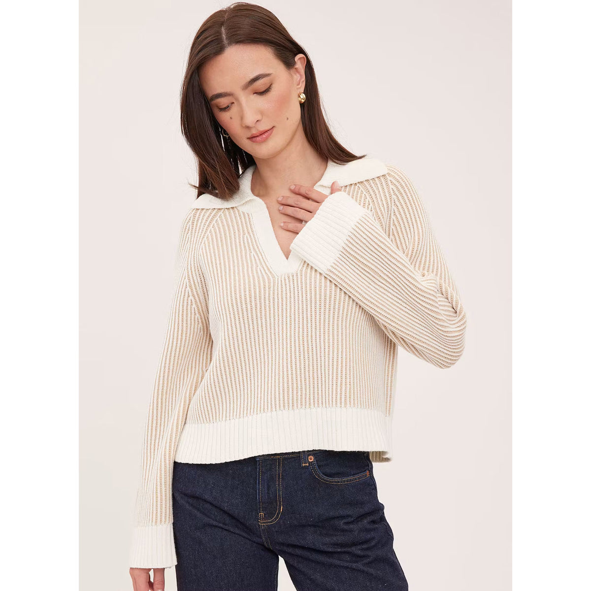 Model wearing Gentle Fawn Xander cream ribbed knit polo collar sweater with dark jeans