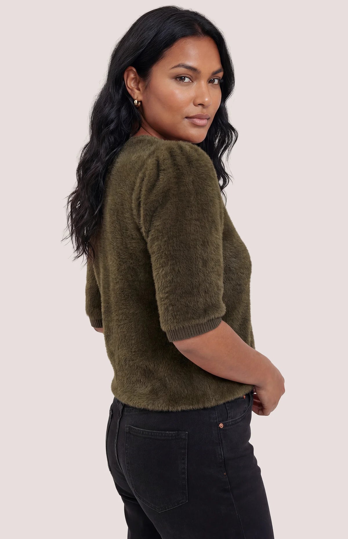 Olive green fuzzy knit elbow-sleeve sweater, back view, paired with black jeans.