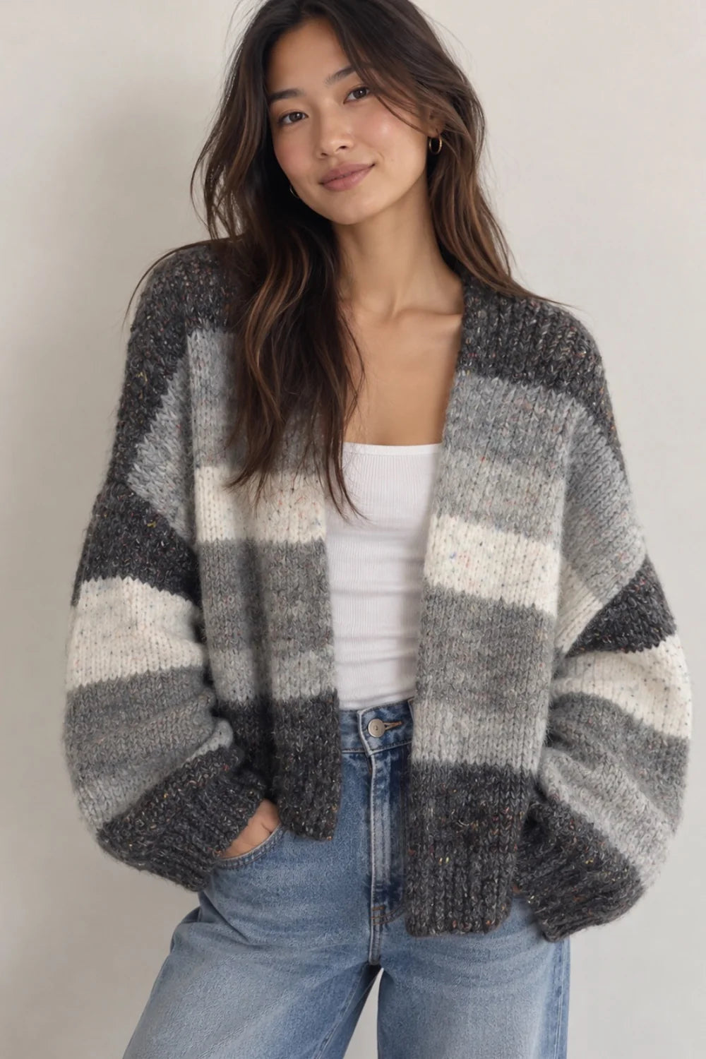 Oversized greyscale striped knit cardigan with cream, grey, and charcoal color blocks