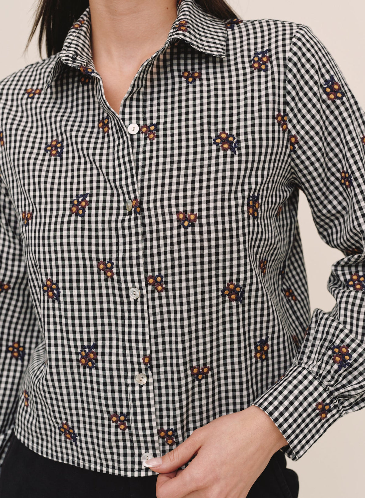 Close-up detail of Bella Dahl gingham crop shirt with navy and gold floral embroidery