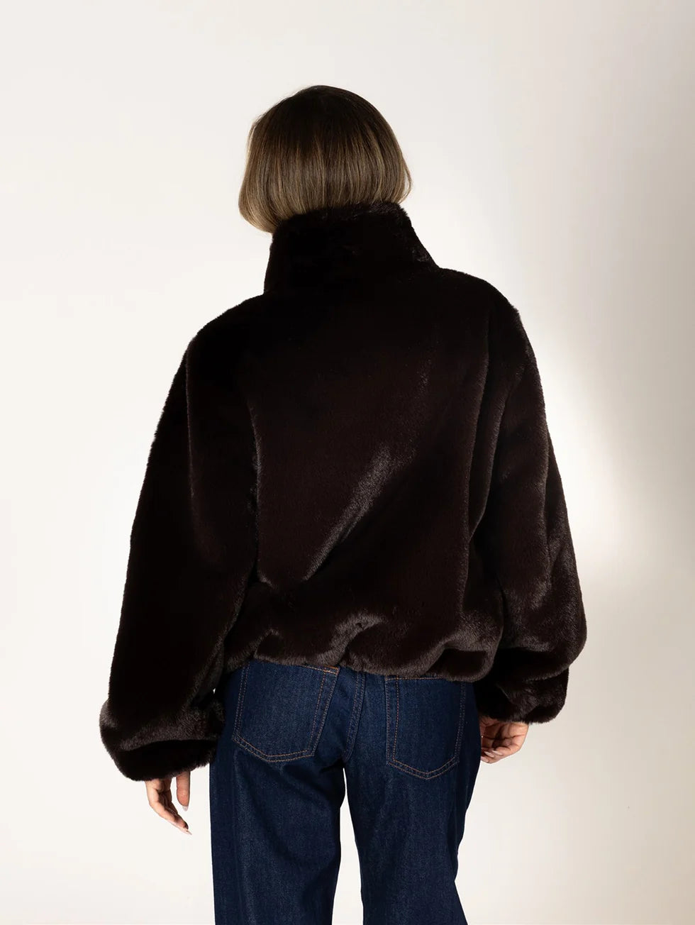 Lyla & Luxe Kendra dark brown faux fur cropped jacket with stand collar, back view