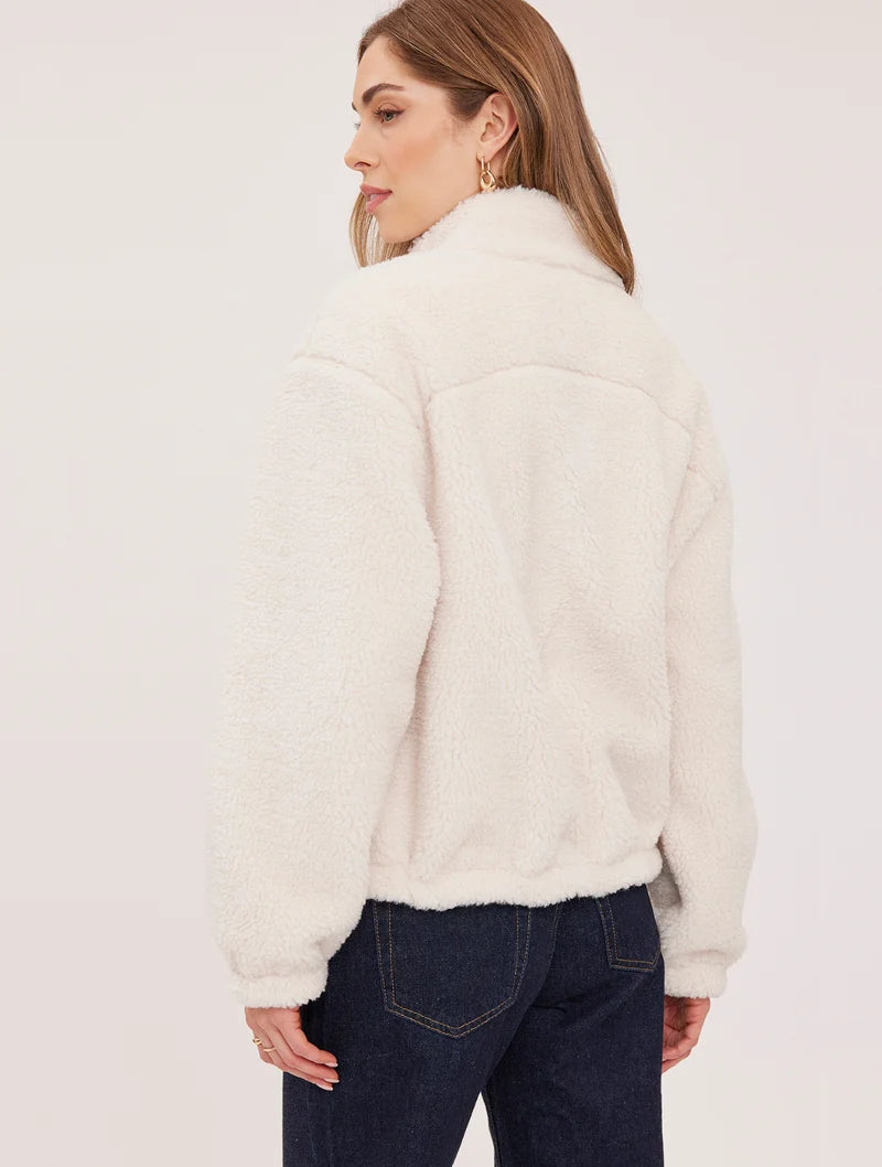Gentle Fawn Camden cream sherpa zip-up jacket, back view, paired with dark jeans