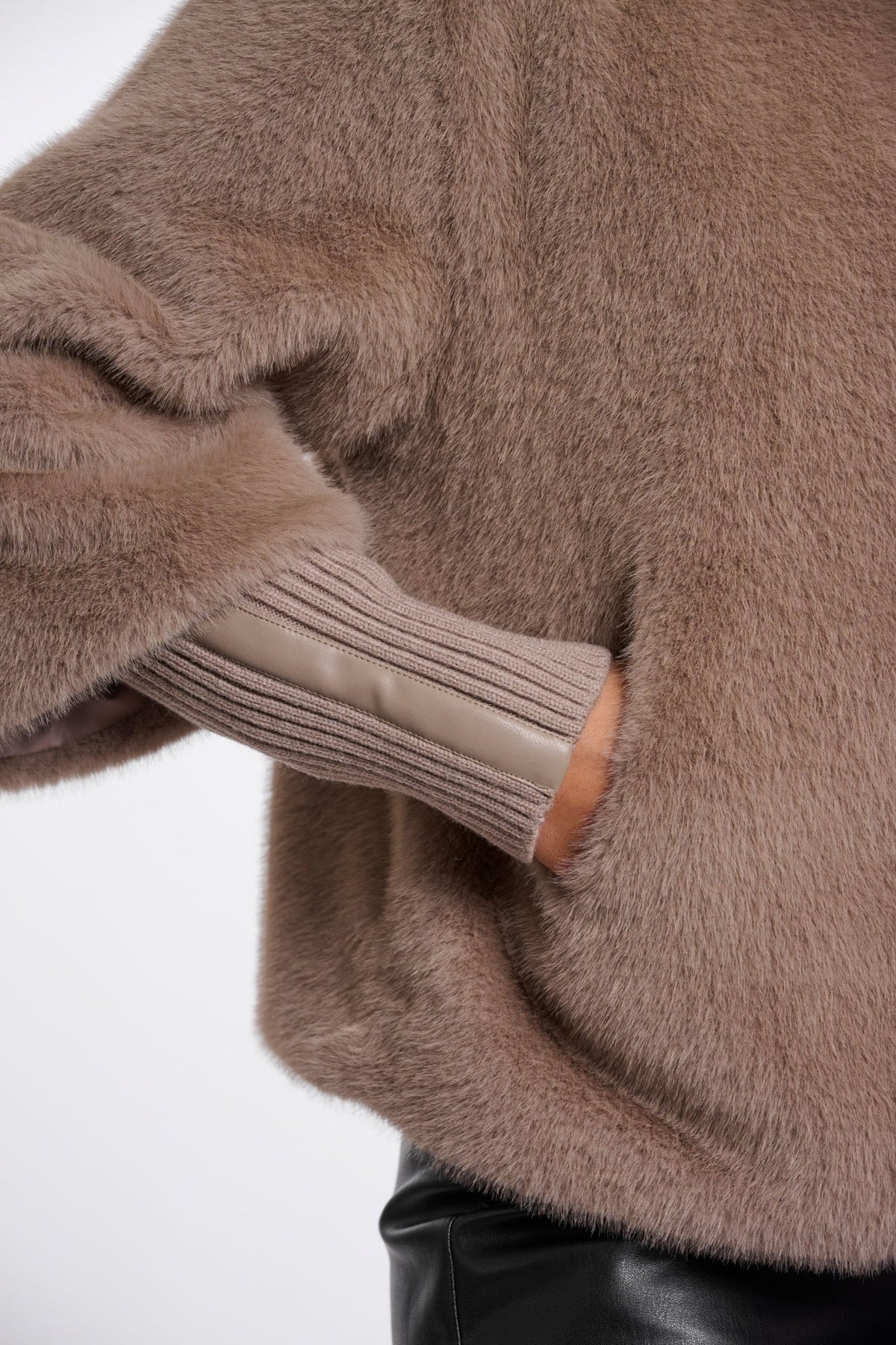 Close-up detail of NESRIN faux fur jacket cuff with ribbed knit trim in mocha latte