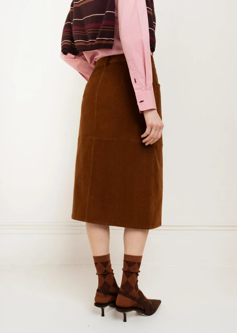 Brown corduroy midi skirt with seam detail, worn with pink shirt and heels