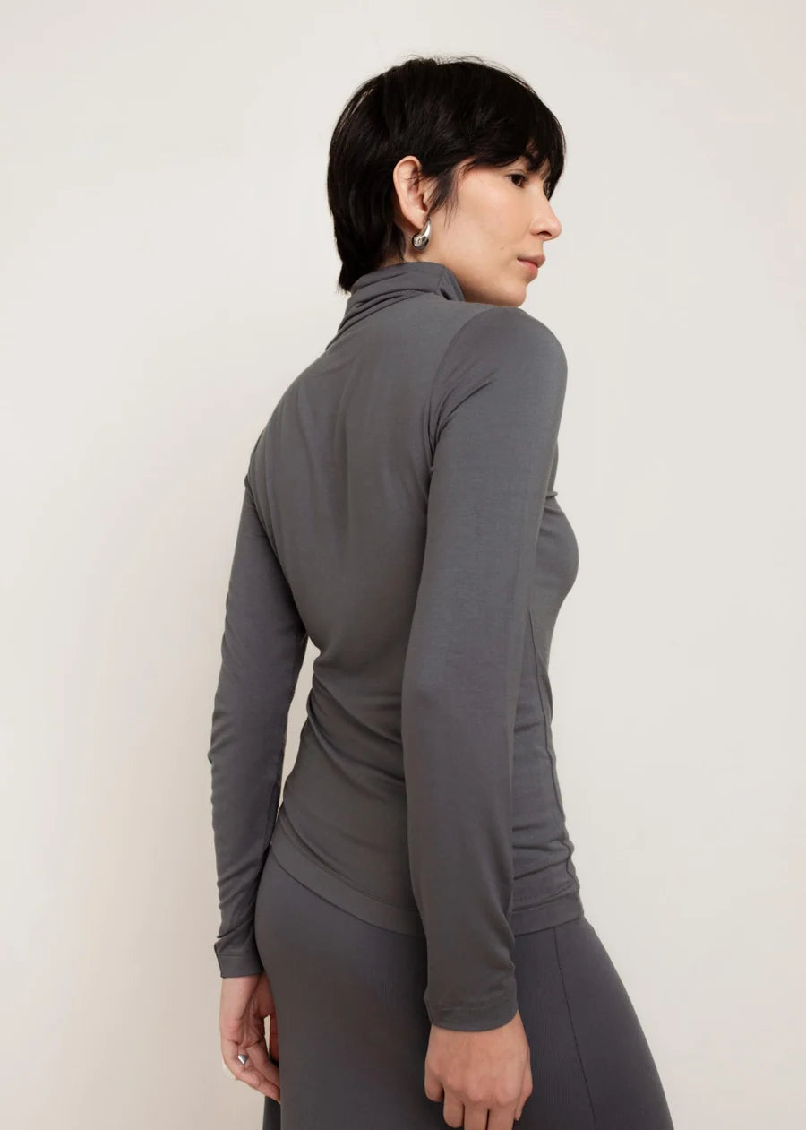 Women's fitted grey long-sleeve turtleneck top, back and side view