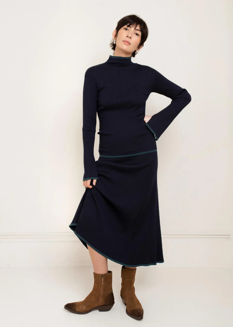 Navy blue midi knit skirt with teal contrast trim, flared silhouette