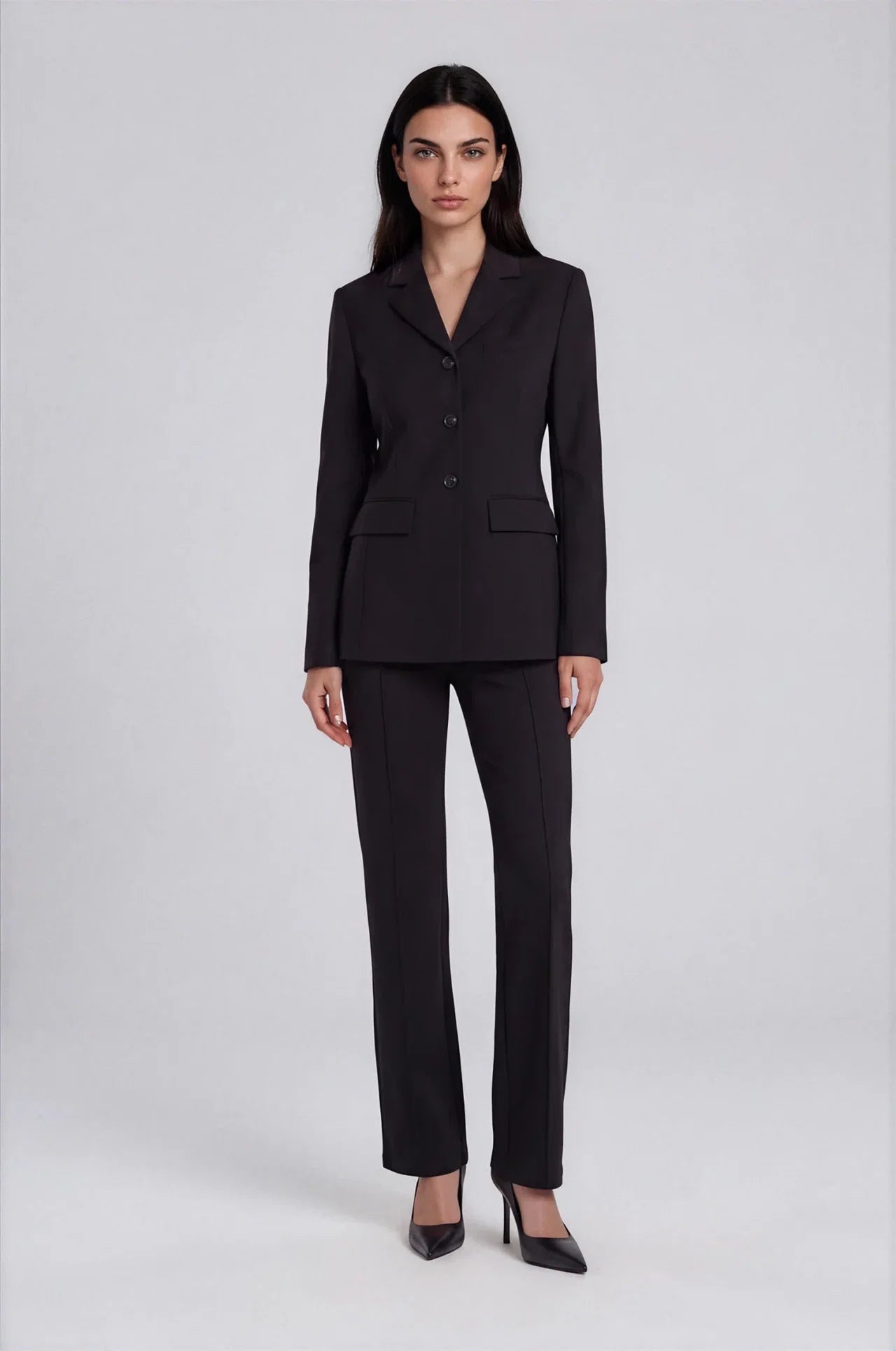 Black straight-leg ponte dress pants with front crease, worn with matching blazer.