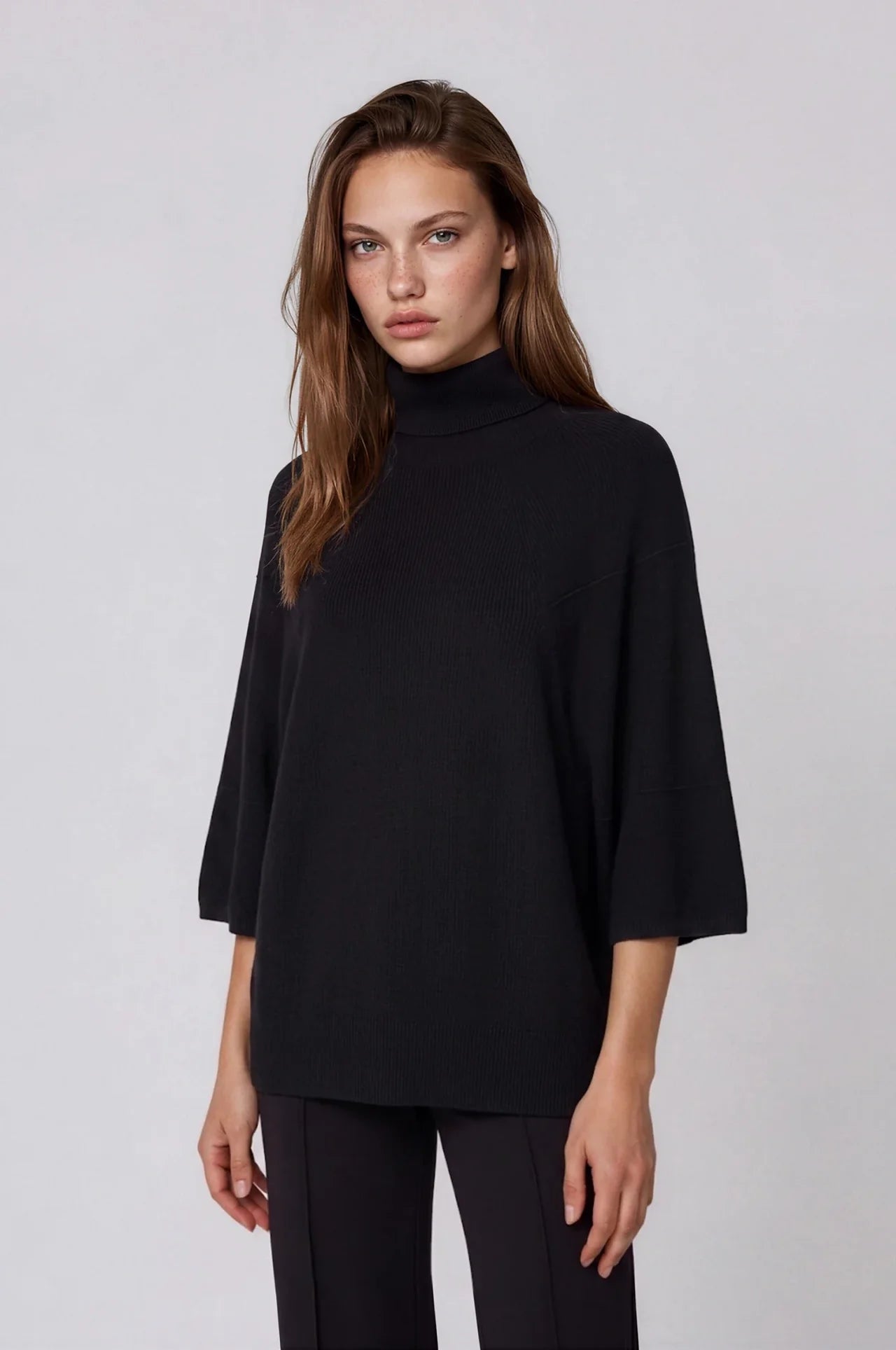 Black oversized turtleneck sweater with 3/4 sleeves and relaxed fit