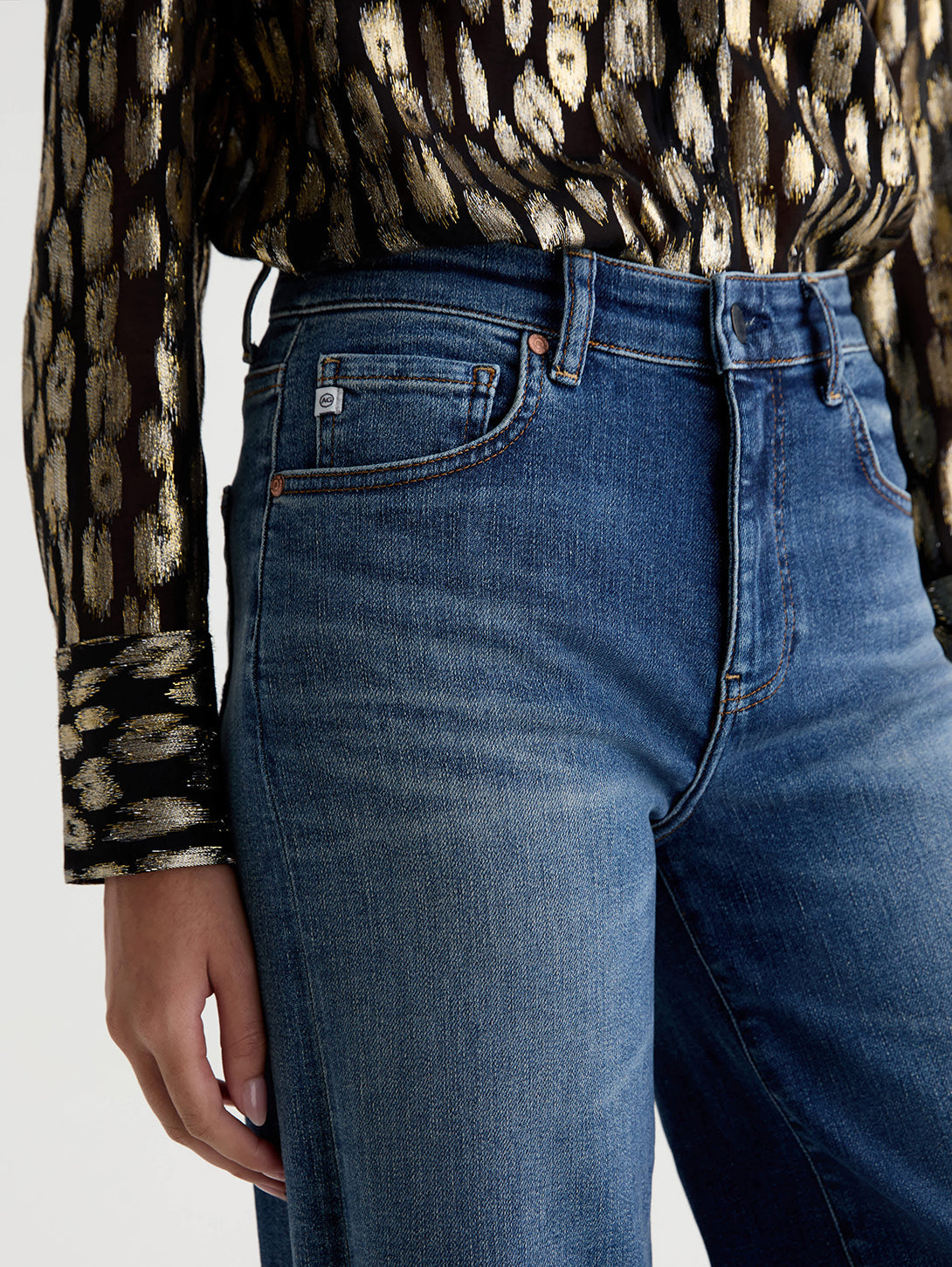 Close-up detail of AG Saige Wide Leg jeans in 14 Years Bluegrass medium blue wash