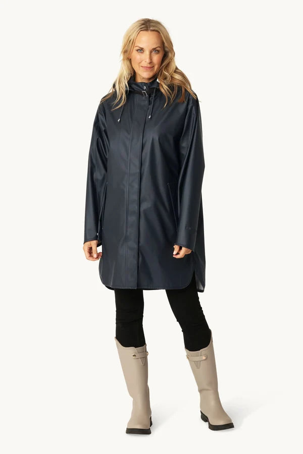 Ilse Jacobsen RAIN71 dark indigo waterproof hooded raincoat, knee length, worn with grey boots