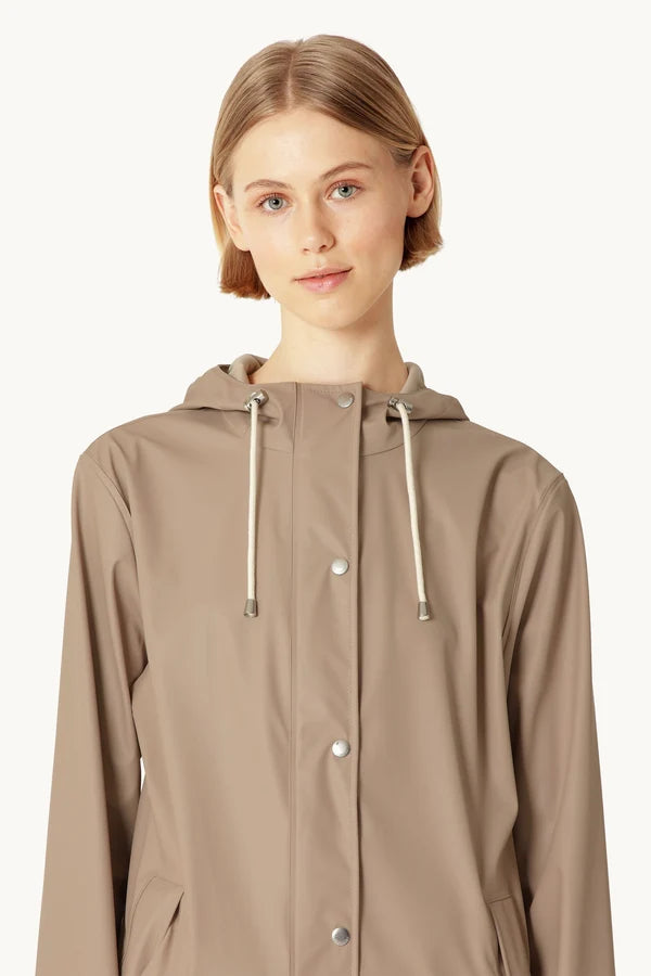Taupe hooded rain jacket with snap buttons and cream drawstring cords