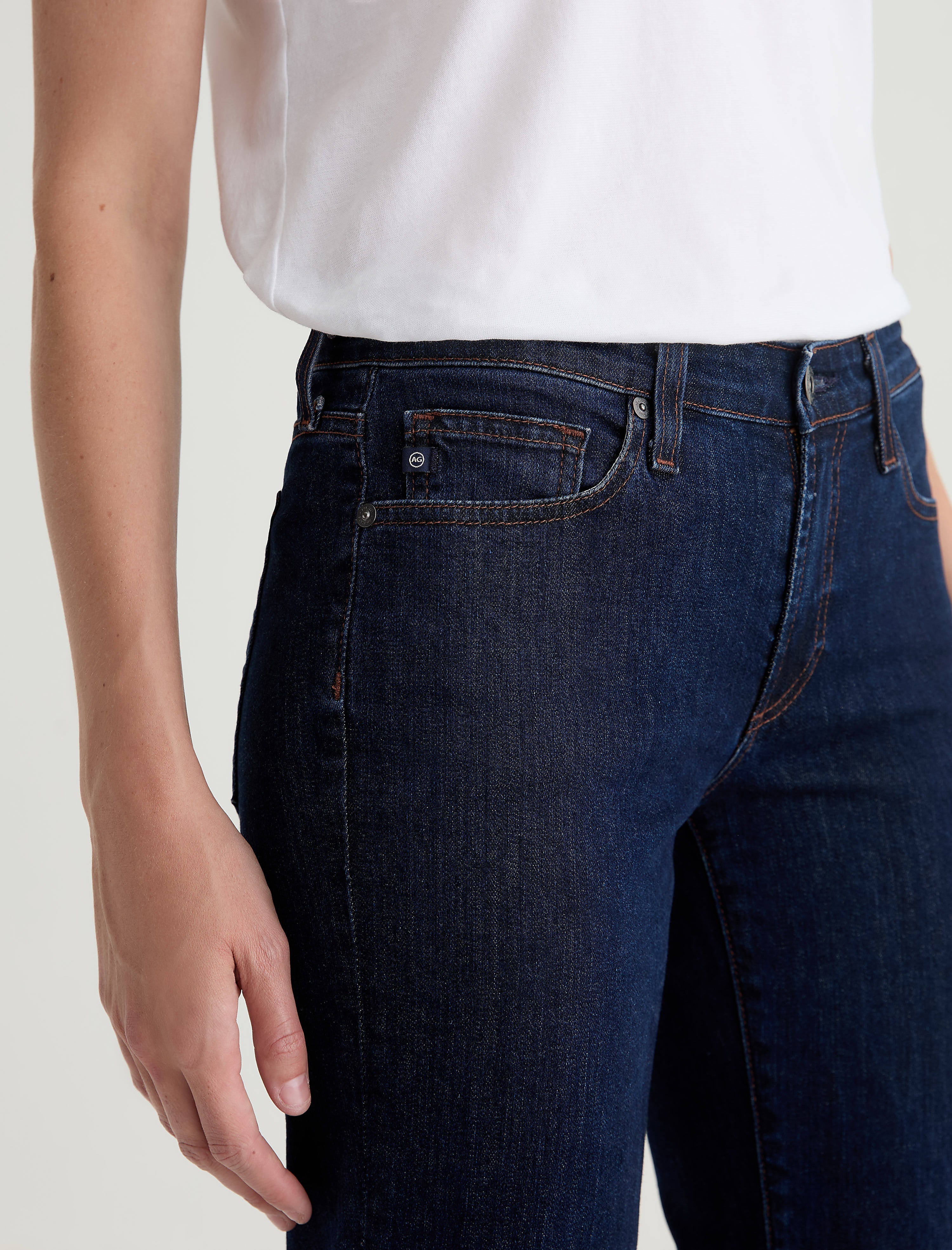 Close-up detail of AG Sandra jeans in deep modern indigo denim with contrast stitching and coin pocket
