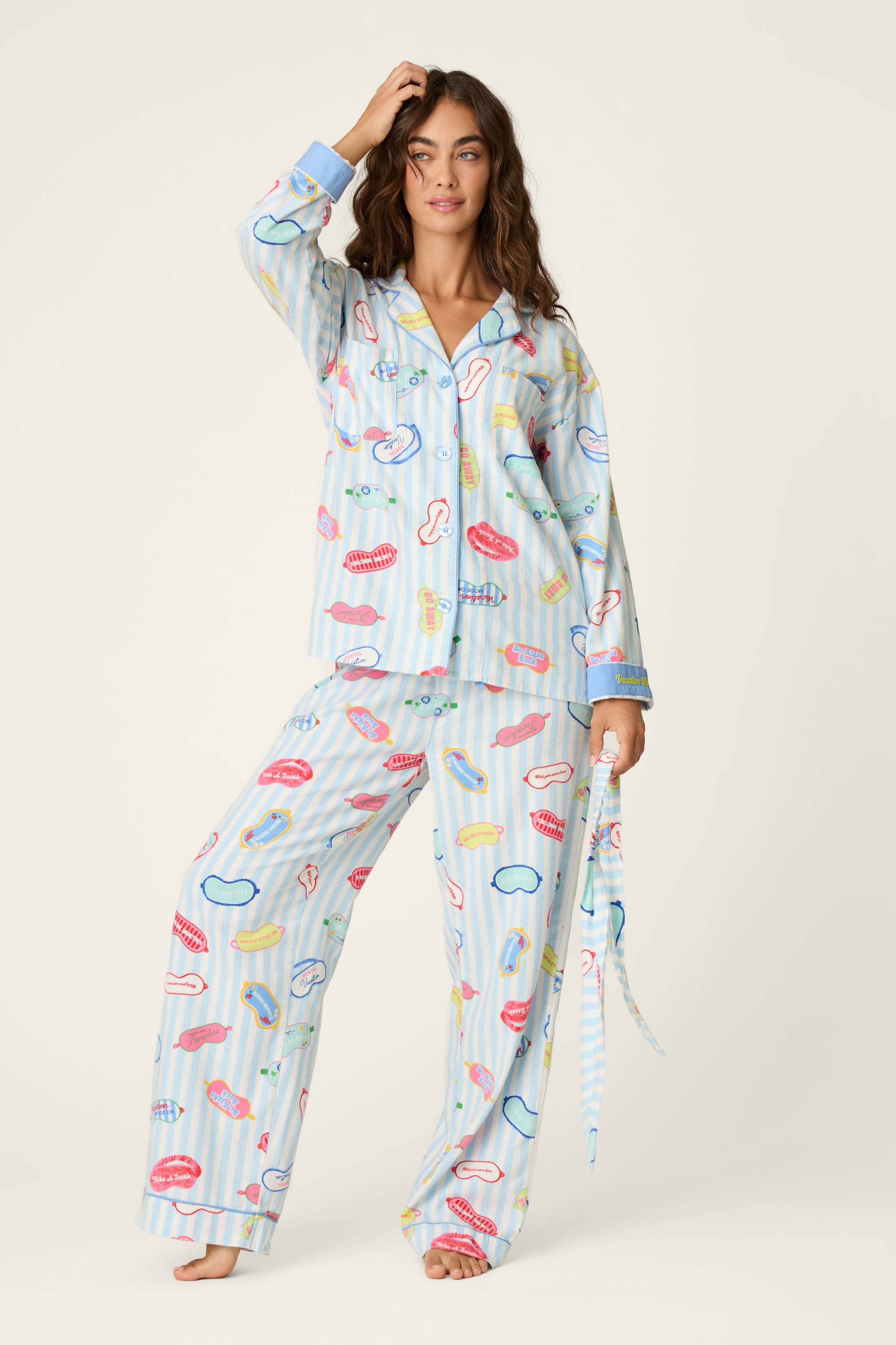 Model wearing PJ Salvage Heritage Set flannel pajamas in light blue stripe with novelty print