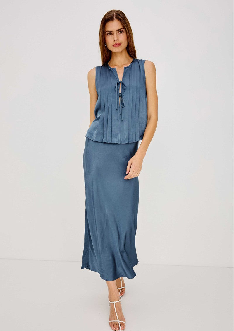 Model wearing Rails AJA sleeveless satin blouse with pintuck pleats in Atlantic blue with matching midi skirt